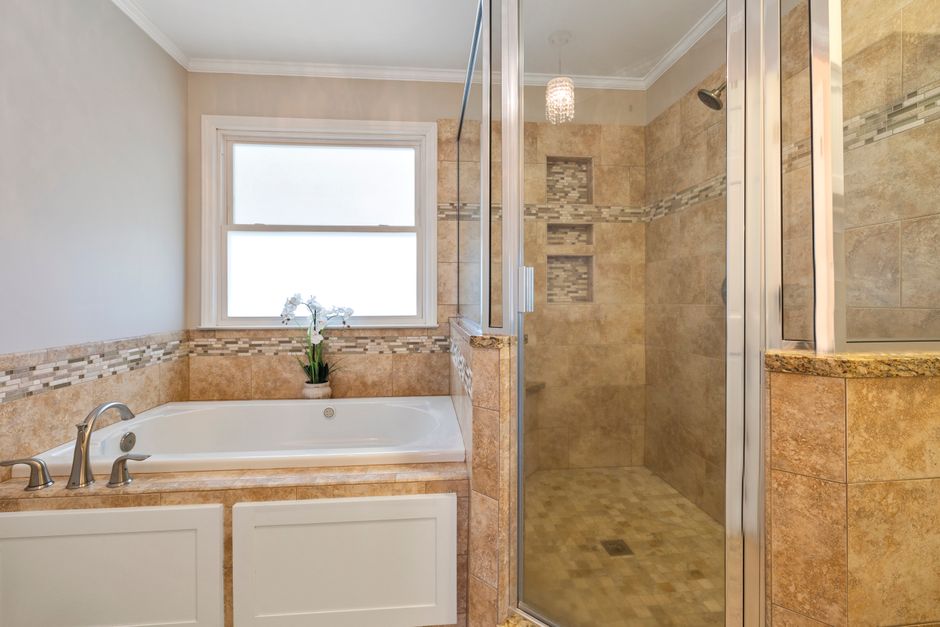 Remodeled bathroom with tile and a shower