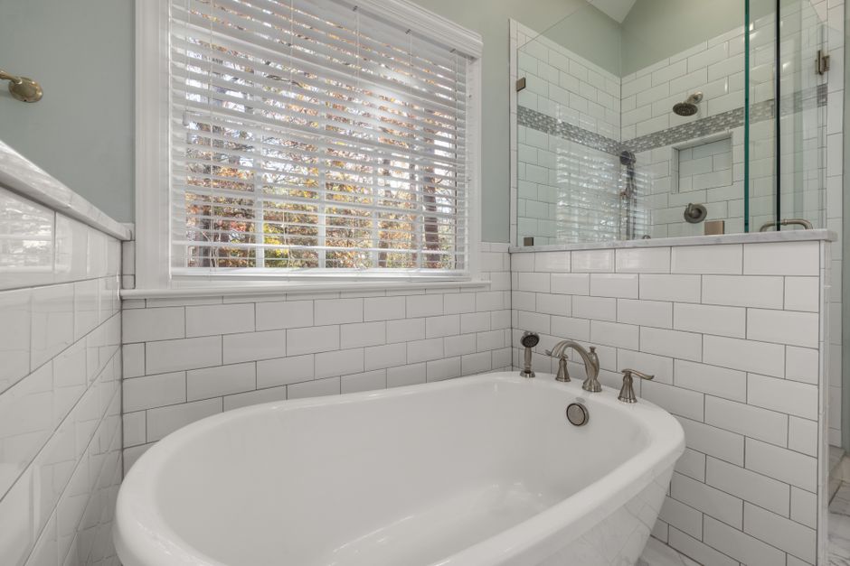 Remodeled bathroom with tile and a shower