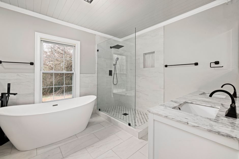Remodeled bathroom with tile and a shower