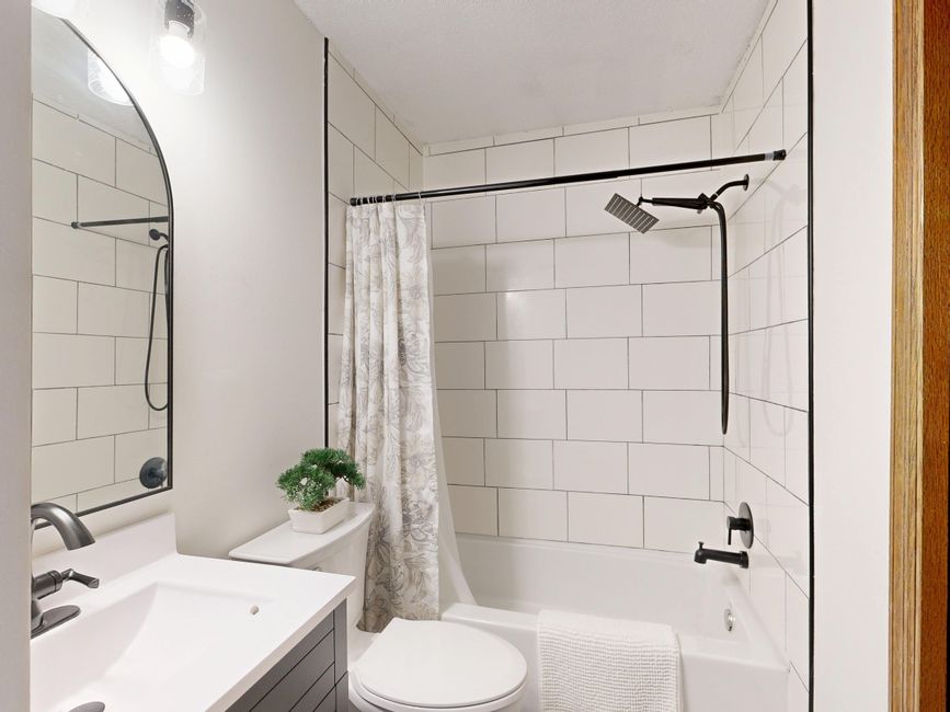 Remodeled bathroom with tile and a shower