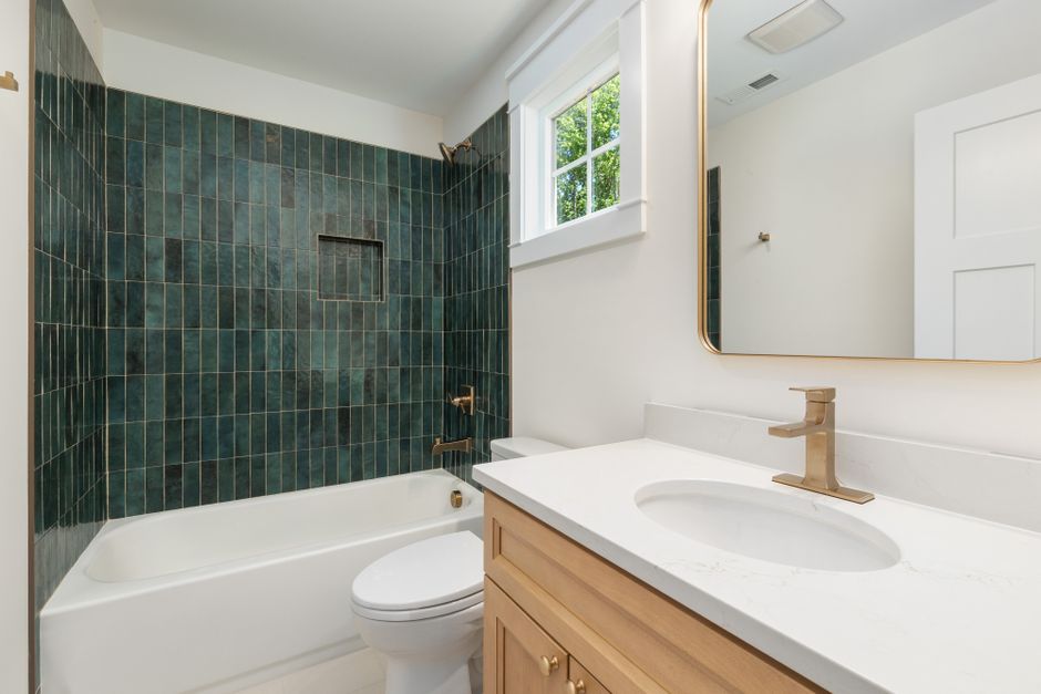 Remodeled bathroom with tile and a shower